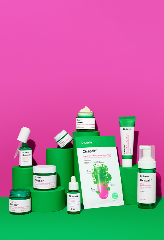 Cicapair Color Correcting Treatment and other Cicapair hero products on a green display in front of a bright pink background.