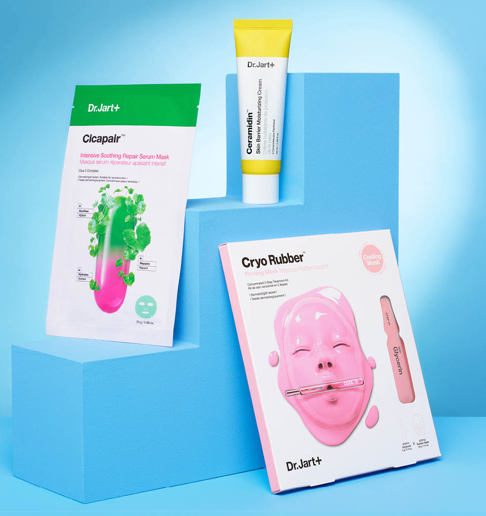 Dr.Jart+ face masks and a tube of Ceramidin Moisturizer Cream are balanced on a light blue podium