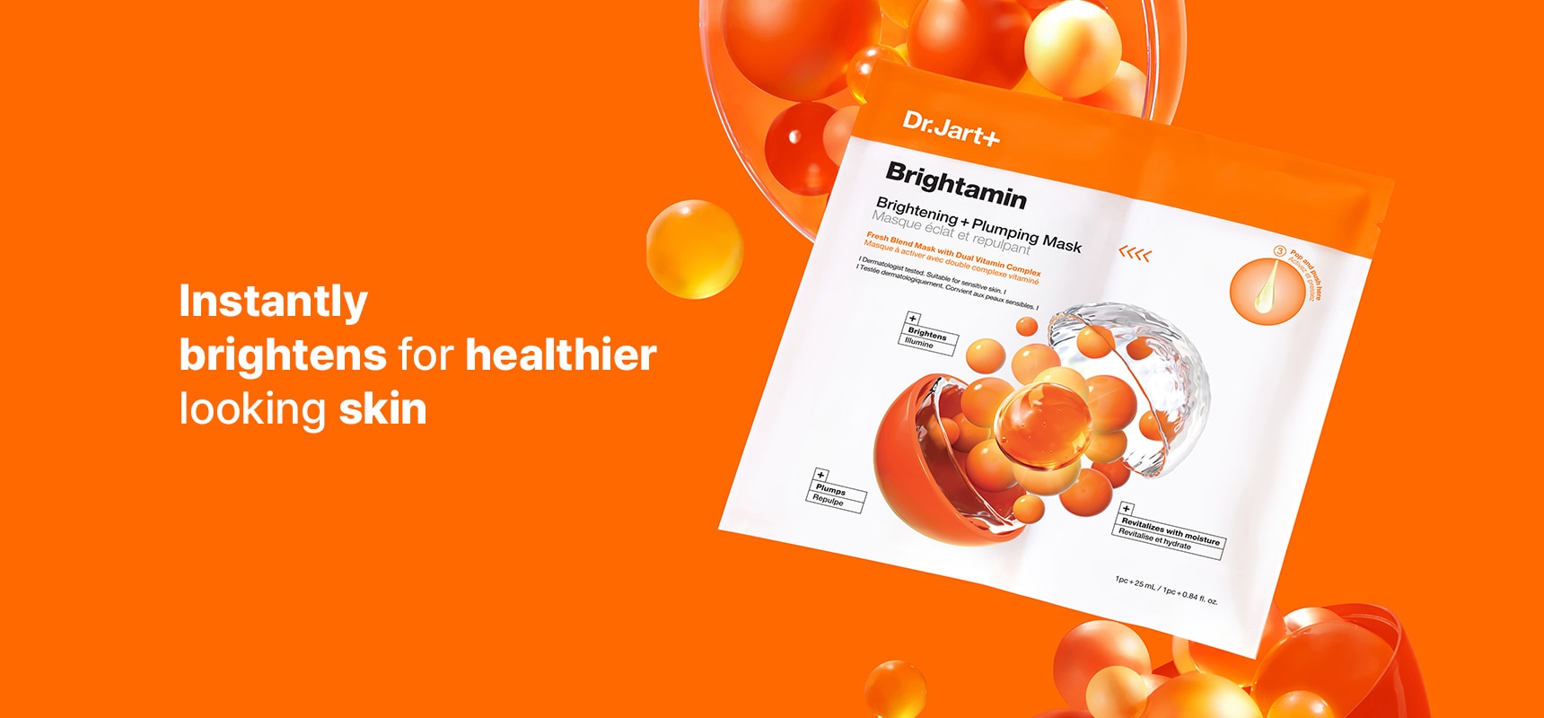 Dr.Jart+'s Brightamin Vitamin C Mask stands in front of an orange background with science-inspired & molecule-like elements