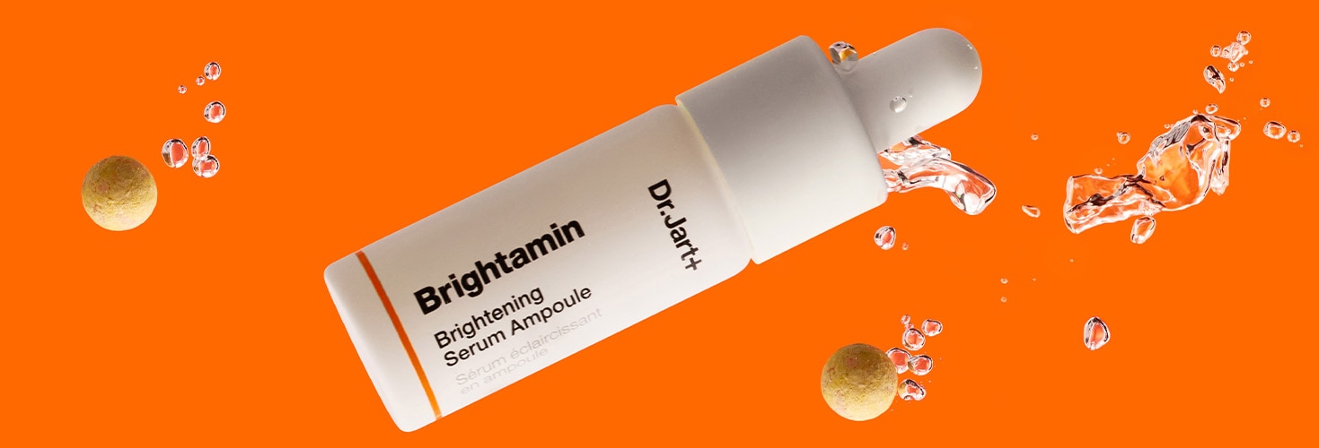 Dr.Jart+ Vital Hydra Solutions Sampl=Brightamin eye stick and Brightamin Serum with vitamin C on a vibrant orange backdrop