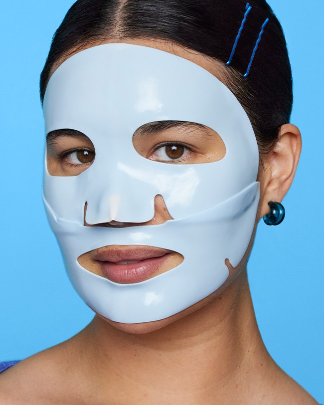 Woman wears Cryo Rubber mask on her face after applying Cryo Rubber mask serum ampoule all over skin.